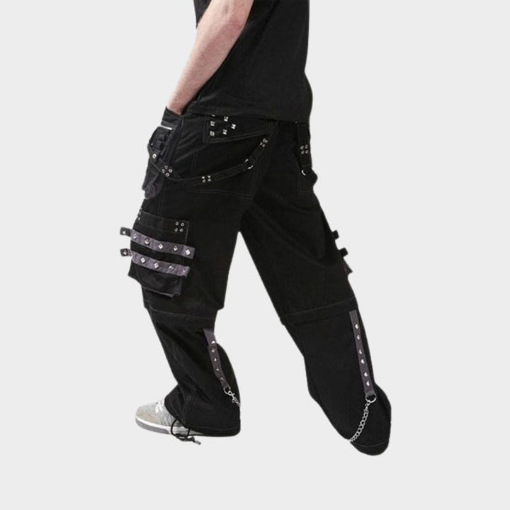 Model in motion showcasing black emo cargo pants with a comfortable fit and multiple pockets, ideal for an active lifestyle.