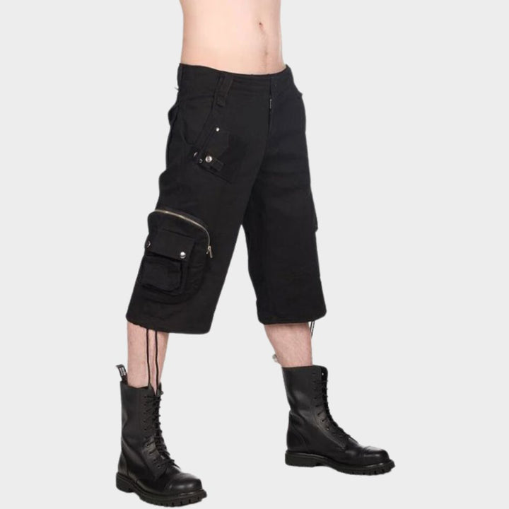 A men wearing black gothic shorts on gothic clothings.