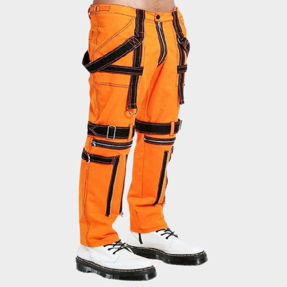 Close-up view of men's orange split cargo pants highlighting the unique design elements: the classic parachute pant silhouette with a canvas band for a vintage feel, and a large cargo pocket with a secure flap closure.